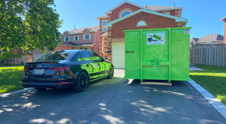 Green Dumpster on Driveway